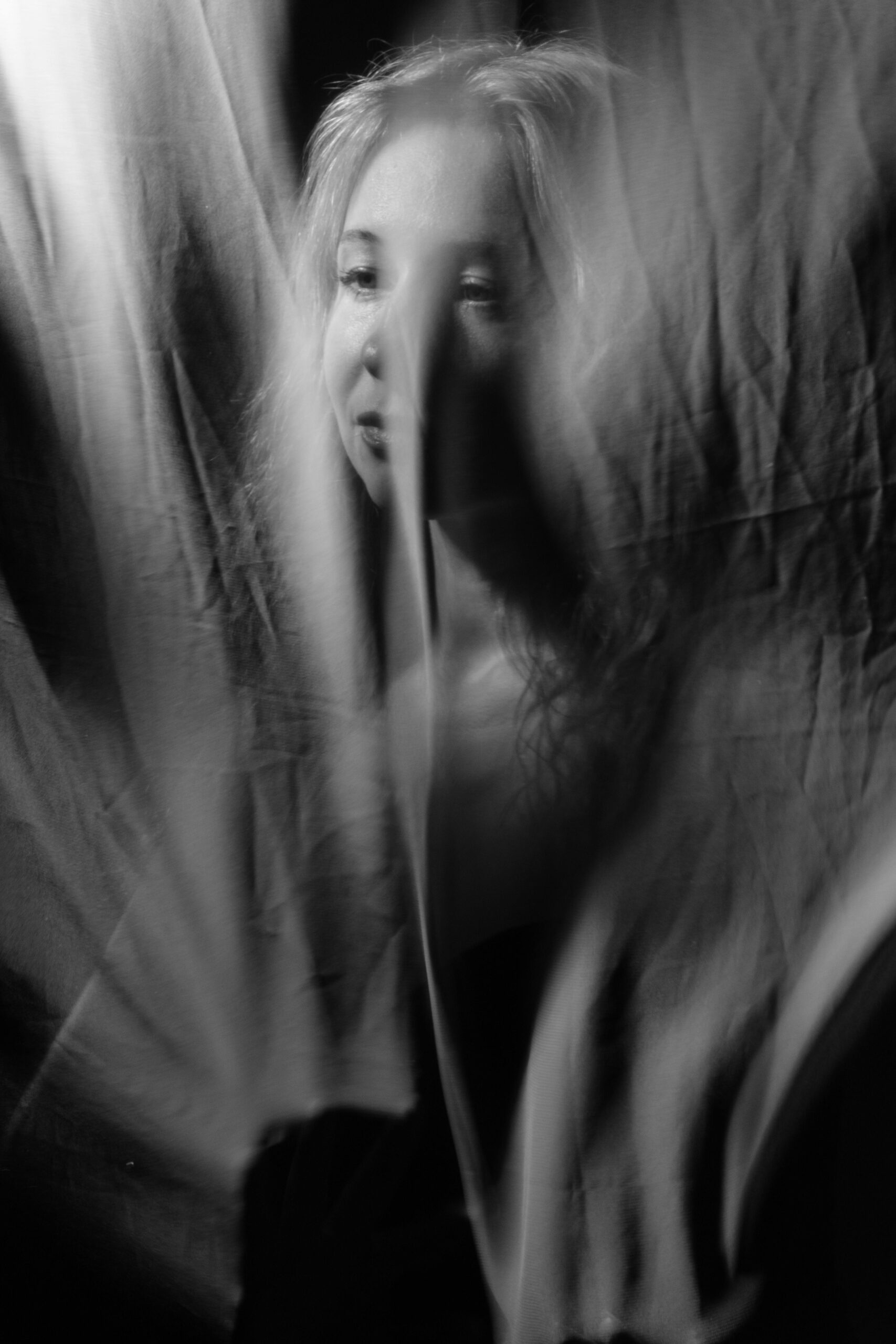 feeling numb represented bye woman behind a curtain