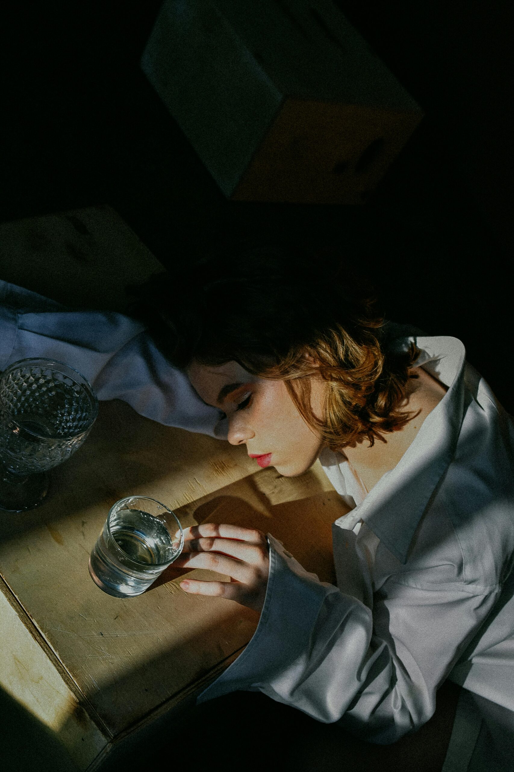 image of woman laying across arm on a table representing over functioning 
